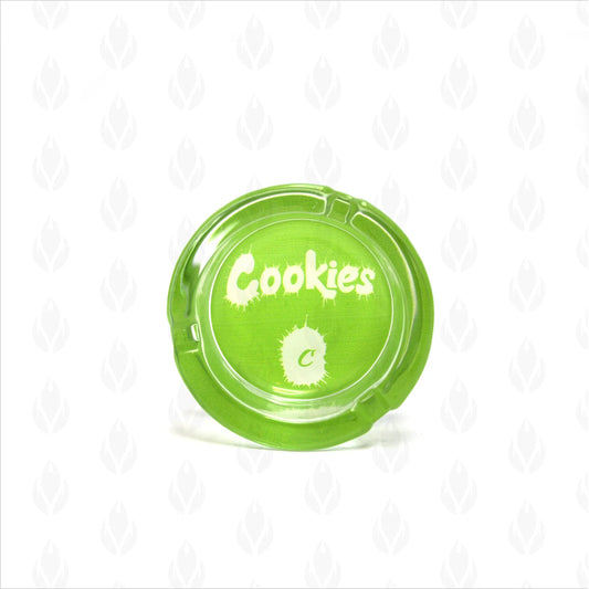 Cenicero de cristal transparente con acentuaciones en verde y logotipo blanco de Cookies, perfecto para interiores y exteriores